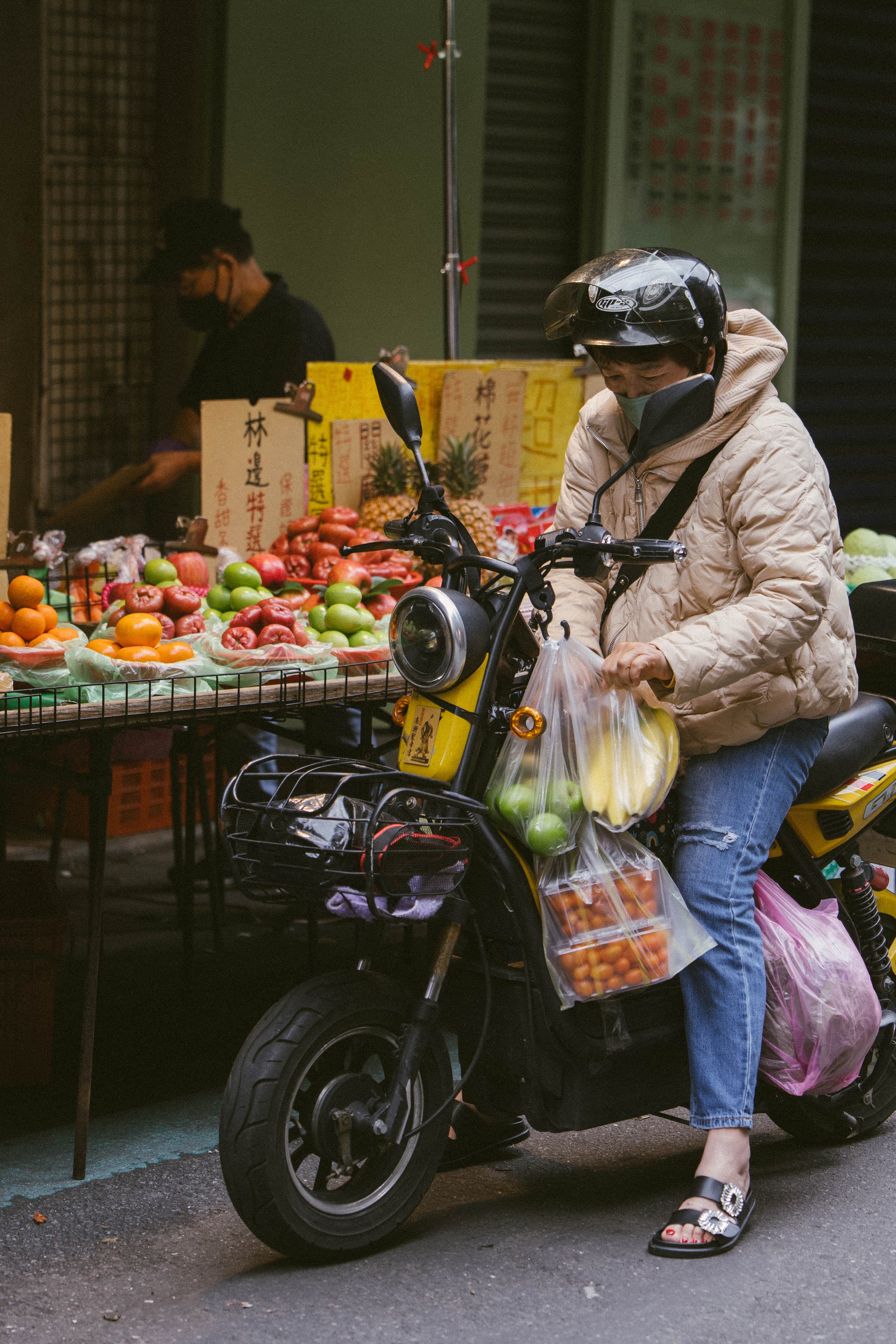 woman on motorcycle with produce